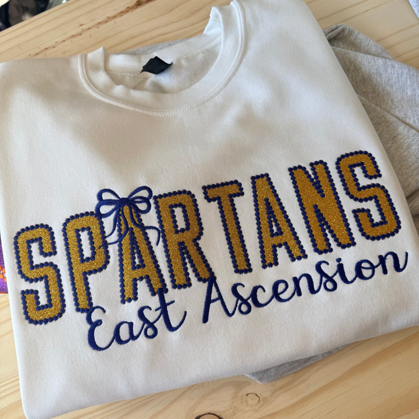 GOLD GLITTER APPLIQUE SPARTANS ON WHITE