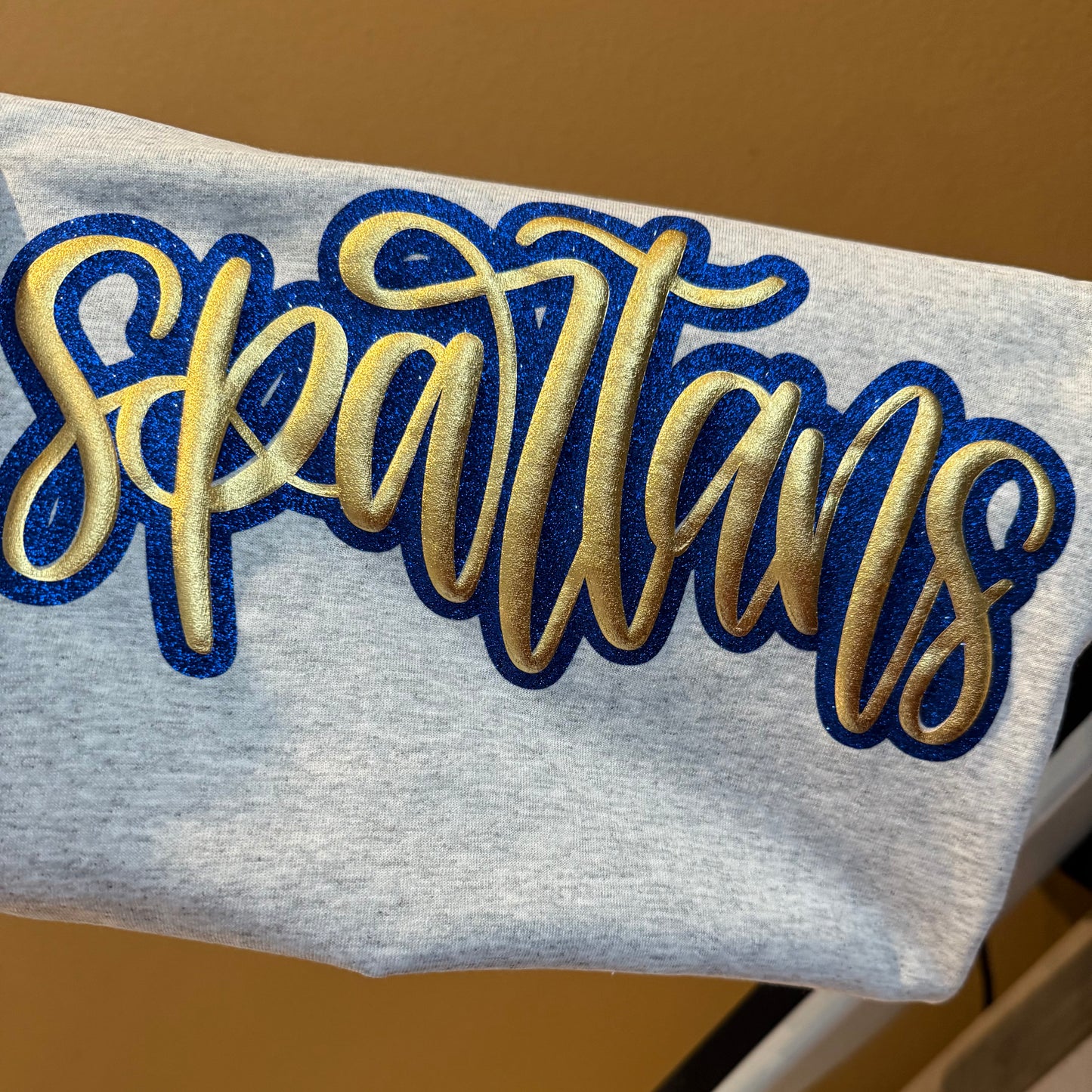 METALLIC GOLD SPARTANS PUFF TEES & SWEATSHIRTS